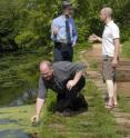 Professors Randall Kerstetter, Joachim Messing and Todd Michael collecting duckweed samples from the Delaware and Raritan Canal in New Jersey.