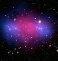 This astounding view of galaxy cluster MACSJ0025 demonstrates how ordinary matter and mysterious dark matter interact. The blue cloud-shaped parts flanking the centre show the position of dark matter, mapped by the Advanced Camera for Surveys onboard the NASA/ESA Hubble Space Telescope. The pink middle indicates ordinary matter, charted by NASA’s Chandra X-Ray Observatory.

The position of the two matter types shown in the image are explained by MACSJ0025’s origin. It was formed when a pair of large galaxy clusters collided. Ordinary matter in the form of hot gas slowed down and pooled at the centre but ghostly dark matter passed straight through.

Hubble used a technique known as gravitational lensing to obtain its data. The light observed was bent by the gravitationally massive galaxy cluster, resulting in an incredibly detailed image. This technique was originally predicted by Einstein.

MACSJ0025 is located in the constellation Cetus, the Whale.