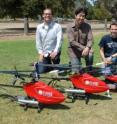 Stanford computer science professor Andrew Ng (center) and his graduate students Pieter Abbeel (left) and Adam Coates have developed an artificial intelligence system that enables these helicopters to perform difficult aerobatic stunts on the their own. The "autonomous" helicopters teach themselves to fly by watching the maneuvers of a radio control helicopter flown by a human pilot.