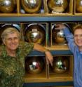 Scripps geoscientists Ray Weiss (green shirt) and Jens Muehle amid collection cylinders used to collect air samples from a variety of locations around the world. Weiss and Muehle led a study that found that the greenhouse gas nitrogen trifluoride, used in the manufacture of flat-panel monitors, escapes to the atmosphere at levels much higher than previously assumed.