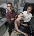 Queen's University Biochemistry Ph.D. student Rachel Hanna checks data from one of the university's diffractometers (on the left) while professors Peter Davies and Rob Campbell look on.