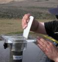 Queen's University Biology professor John Smol extrudes a sediment core into sections.