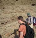 UC Riverside's Gordon Love examining rock strata in northern Oman.