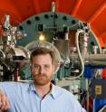 Darryl Granger, a Purdue professor of earth and atmospheric sciences, stands with the accelerator mass spectrometer used in a study that determined the age of "Peking Man" was around 200,000 years older than previously thought. Purdue is the only university in the nation with an accelerator mass spectrometer powerful enough to perform the type of testing used in this study.