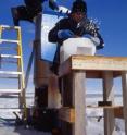 CU-Boulder postdoctoral researcher Vasilii Petrenko, foreground, cleans a sample ice block from Greenland while Scripps Institution of Oceanography Professor Jeff Severinghaus loads another ice block into a vacuum melting tank.