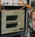 Scripps researcher Kerri Pratt with aerosol time-of-flight mass spectrometer (ATOFMS) aboard a specially outfitted C-130 aircraft operated by the National Center for Atmospheric Research in the skies over Wyoming. Scripps-led researchers made the first direct detections of airborne bacteria in clouds aboard the aircraft, and reported the results in the May 17 online edition of the journal <i>Nature Geoscience</i>.