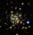 This image of the Arches Cluster of young, massive stars was obtained with NACO on ESO's Very Large Telescope. The field of view is 28 arcseconds. North is up and east is to the left. This image is a composite of infrared images obtained through J, H and K filters. The stars appear as bright cores surrounded by faint diffuse halos. This is typical of images obtained by adaptive optics instruments. The halo corresponds to light that was not fully corrected for the blurring effects of the Earth's atmosphere.