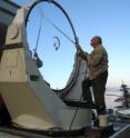 UC Berkeley physicist Charles Townes, who won the 1964 Nobel Prize in Physics for invention of the laser, cleans one of the large mirrors of the Infrared Spatial Interferometer. The ISI is on the top of Mt. Wilson in Southern California.