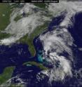 GOES-12 captured the lows on July 22 at 10:31 a.m. EDT (1431 UTC). The satellite image shows two comma-like cloud formations, one east of Florida's east coast, and the other with its "tail" over Hispaniola. Both have a low chance of developing into a tropical depression according to the National Hurricane Center.