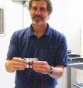 Bruce Logan, Kappe Professor of Environmental Engineering, Penn State, holds three chambered microbial desalination cells.