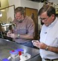 Charles Beeker, left, and Geoffrey Conrad examine some of the bones and lithics, which have been transported to Beeker's underwater science lab for further study.