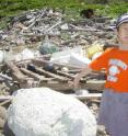 A boy in Japan points out Styrofoam debris from the ocean.