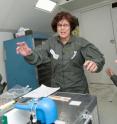 University of Utah chemist Lorraine Siperko experiences weightlessness during a flight aboard a NASA "vomit comet" aircraft. Siperko made several such flights to test a new system designed to monitor drinking water quality aboard spacecraft. The system includes a commercially available color sensor (blue device in foreground) that checks the level of disinfectant in drinking water. The water quality monitoring system was delivered to the International Space Station in August for six months of tests.