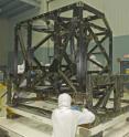 NASA engineers check out the unwrapped ISIM structure in a clean room. The ISIM Structure supports and holds four Webb telescope science instruments.