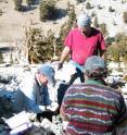 University of Arizona tree-ring researcher Matthew Salzer (L) examines a small piece of dead remnant bristlecone. He, Jim Parks, also of UA's Laboratory of Tree-Ring Research (center) and photographer Gary Braasch (R) are on Sheep Mountain in the White Mountains of California.