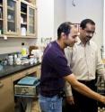 NJIT's Pushpendra Singh (right) and his graduate student examine particles in a dish.