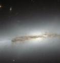 Still an astrophysical mystery, the evolution of the bulges in spiral galaxies led astronomers to the edge-on galaxy NGC 4710. When staring directly at the centre of the galaxy, one can detect a faint, ethereal "X"-shaped structure. Such a feature, which astronomers call a "boxy" or "peanut-shaped" bulge, is due to the vertical motions of the stars in the galaxy's bar and is only evident when the galaxy is seen edge-on. This curiously shaped puff is often observed in spiral galaxies with small bulges and open arms, but is less common in spirals with arms tightly wrapped around a more prominent bulge, such as NGC 4710.