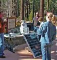 Nevada Seismological Laboratory director Graham Kent presents the new solar-powered wi-fi Forest Eye camera system to students who developed novel idea for early-detection of forest fires.