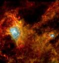 An unseen stellar nursery comes into view in this Herschel image. Some 700 newly-forming stars are estimated to be crowded into these colorful filaments of dust. The complex is part of a mysterious ring of stars called Gould's Belt.

This image shows a dark cloud 1000 light-years away in the constellation Aquila, the Eagle. It covers an area 65 light-years across and is so shrouded in dust that no previous infrared satellite has been able to see into it. Now, thanks to Herschel's superior sensitivity at the longest wavelengths of infrared, astronomers have their first picture of the interior of this cloud.

It was taken on October 24, 2009, using two of Herschel's instruments: the Photodetector Array Camera and Spectrometer and the Spectral and Photometric Imaging Receiver. The two bright regions are areas where large newborn stars are causing hydrogen gas to shine.