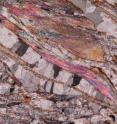 This is a look at the foliated microstructure at the microscale: talc lamellae (bright coloRs) and calcite veins (white-grey).