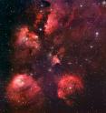 The Cat's Paw Nebula (NGC 6334) is a vast region of star formation. This new portrait of NGC 6334 was created from images taken with the Wide Field Imager instrument at the 2.2-m MPG/ESO telescope at the La Silla Observatory in Chile, combining images taken through blue, green and red filters, as well as a special filter designed to let through the light of glowing hydrogen. NGC 6334 lies about 5,500 light-years from Earth in the constellation of Scorpius. The whole gas cloud is about 50 light-years across.

NGC 6334 is one of the most active nurseries of massive stars in our galaxy and has been extensively studied by astronomers. The nebula conceals freshly minted brilliant blue stars — each nearly ten times the mass of our Sun and born in the last few million years. The region is also home to many baby stars that are buried deep in the dust, making them difficult to study. In total, the Cat’s Paw Nebula could contain several tens of thousands of stars.

The nebula appears red because its blue and green light are scattered and absorbed more efficiently by material between the nebula and Earth. The red light comes predominantly from hydrogen gas glowing under the intense glare of hot young stars.