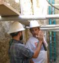 Dr. Olaf Zielke and Professor J. Ramon Arrowsmith of Arizona State University stand in the bottom of a trench across the San Andreas fault zone in the Carrizo Plain and discuss the exposures of faulted sediments and channel gravel visible in the walls.