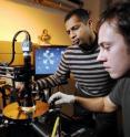 Researchers Raghunath Murali and graduate student Kevin Brenner (front) perform electrical measurements on a graphene sample  under high vacuum in a cryogenic probe station.