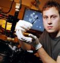 Graduate student Kevin Brenner holds a fabricated graphene sample.