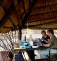 This image shows Stephan Schuster, of Penn State University in the United States, and Vanessa Hayes, of the University of New South Wales in Australia, preparing genetic samples in their field laboratory in Namibia.  The two scintists led a research team that sequenced human genomes from Southern African Bushmen and a Bantu individual, Archbishop Desmond Tutu.  The goal of the research it to achieve a greater understanding of human genetic variation and its effect on human health.  Human genomics is a powerful and rapidly emerging medical resource.  The scientists say they need to learn the full range of human genetic variation in order to learn how genes affect health, and that Southern Africa is the place to look.  The study revealed that, on average, there are more genetic differences between any two Bushmen in the study than between a European and an Asian.

The study used three new DNA-sequencing technologies, which deliver genetic information with unprecedented economy and speed.  The project compares the strengths of current sequencing technologies, and it demonstrates that their combination results in data that is more accurate than from projects using only one of these methods.