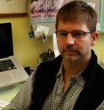 This is William Cresko, a biologist at the University of Oregon, in his office in January 2010. His lab teamed with a second UO lab on a comprehensive genetic comparison of populations of saltwater and freshwater threespine stickleback, finding regions of genes involved in their evolution.