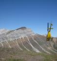 In this photo from Canada's Yukon Territory, an iron-rich layer of 716.5-million-year-old glacial deposits (maroon in color) is seen atop an older carbonate reef (gray in color) that formed in the tropics.