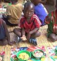 Zambian children eat a biofortified high-carotenoid maize meal as part of a feeding trial and nutritional study.