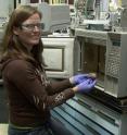 Tara Lovestead prepares a sample of meat (by excising a few milligrams) for testing with a new sampling method developed by NIST researcher Tom Bruno that can detect trace amounts of low volatility compounds produced when perishable foods such as chicken begins to spoil.