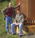 Iowa State University's Jon "Matt" Rouse, left, and Casey Faber have designed a new kind of power pole that would be more reliable and cost effective than the current generation of transmission poles, such as this old-style structure just east of campus.