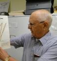 Dr. Alfred Ernest Schuyler, curator emeritus of botany at the Academy of Natural Sciences in Philadelphia says the delta bulrush could help ease the Gulf oil spill crisis. Schuyler, a prominent botanist who first profiled and then named the delta bulrush, says the plant has natural properties that could help reduce the impact of the spill on the Mississippi delta. He is urging all sides involved in the crisis to give this slender sedge family member a hard look as they weigh their spill-fighting strategies. Schuyler, holding the type specimen from the Academy's botany collection, described and named <I>Scirpus deltarum,</I> now known as <I>Schoenoplectus deltarum.</I>