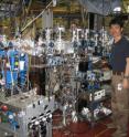 University of Arizona researcher Hiroshi Imanaka stands next to the experiment he and UA's Mark Smith have set up inside the Advanced Light Source facility at Lawrence Berkeley National Laboratory in Berkeley, Calif.