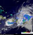 TRMM captured the image of System 97L's rainfall on July 20 at 9:36 p.m. EDT. The red areas indicate heavy rainfall of over 50 millimeters (~2 inches) per hour. The yellow and green areas indicate moderate rainfall between .78 to 1.57 inches per hour.