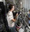 Purdue nuclear engineering doctoral student Chase Taylor, at left, and Jean Paul Allain, an assistant professor of nuclear engineering, are using this facility in work aimed at developing coatings capable of withstanding the grueling conditions inside nuclear fusion reactors. The research focuses on the "plasma-material interface," a crucial region where the inner lining of a fusion reactor comes into contact with the extreme heat of the plasma.