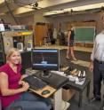 ISU kinesiology master's student Danielle Barkema (left) and kinesiology professor and chair Phil Martin (right) used sensors, accelerometers and lab equipment such as a force platform and markers/cameras while testing subjects, like kinesiology master's student Alison Glidden (center), in their research on prolonged wearing of and walking in high heels.