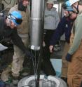 IceCube scientists deploy a calibration light source, called the Standard Candle in one of the  2.5 km deep holes. Each of the 86 holes contains a string of 60 Digital Optical Modules (DOMs) that detect the blue light from neutrino events in the deep, clear ice.