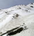 "Zebra stripes" of dust and snow are visible on the snow surface in Colorado's mountains.