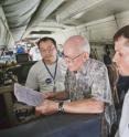 GRIP mission scientist Ed Zipser (center), of the University of Utah, reviews flight plans during one of the DC-8's final flights with Matt He (left), NASA's Marshall Space Flight Center) and Utah student Jon Zawislak.