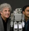 Andrew Meltzoff, co-director of the University of Washington's Institute for Learning and Brain Sciences, and Rajesh Rao, University of Washington associate professor of computer science and engineering, with the humanoid robot used to demonstrate "social" interactions to babies.