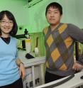 Mei Hong of Iowa State University and the Ames Laboratory, left, and Fanghao Hu of Iowa State used solid-state nuclear magnetic resonance spectroscopy to investigate the proton channel that connects a flu virus to a healthy cell.