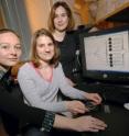 Georgia Tech engineers Catherine Rivet, Abby Hill and Melissa Kemp (left-right) display a diagram of the microfluidic device they used to assess T cells. The drawing illustrates the different channels corresponding to the eight time points, ranging from 30 seconds to seven minutes, where they collected signaling event measurements from the cells.