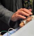 The patient's mother reaches out to touch her daughter's new hand after surgeons performed the first hand transplant in the western United States at Ronald Reagan UCLA Medical Center in Los Angeles, March 5, 2011.