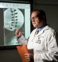 Daniel Green, M.D., pediatric orthopedic surgeon at Hospital for Special Surgery, examines images showing fusion for adolescent idiopathic scoliosis using the newer generation spine implants.