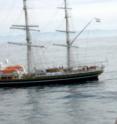 A photo of Dr. Lisa Beal being interviewed by Dutch radio during a rendezvous between Research Vessel Knorr and Clipper Stad Amsterdam off the African Cape. RV Knorr was returning to Cape Town after deploying current meter moorings across the Agulhas Current during the first cruise of the Agulhas Current time-series experiment. Clipper Stad Amsterdam was re-sailing the voyage of the Beagle, on which Darwin collected specimens from around the world and derived his theory of evolution.