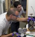 Scientists Sean Sylva (left) and Jeff Seewald extract a sample and collect its oil, gas components.