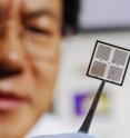 Regents professor Zhong Lin Wang holds an array of piezoelectrically modulated resistive memory (PRM) cells on which metal electrodes have been patterned using lithography.